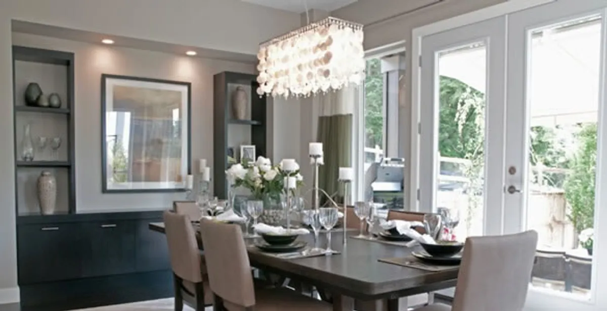 Elegant dining room chandelier installation above table in Memphis, TN