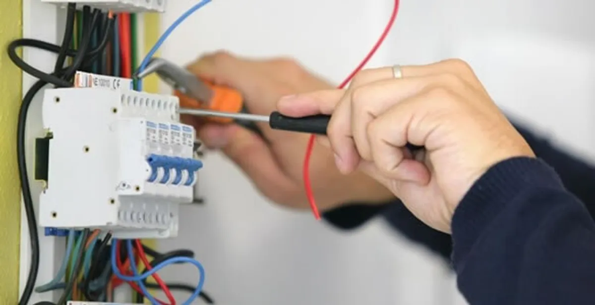 Electrician installing and adjusting circuit breakers in an electrical panel in Memphis, TN