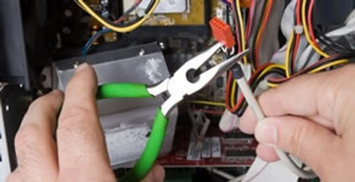 Licensed electrical contractor performing electrical repair with tools in Walls, MS