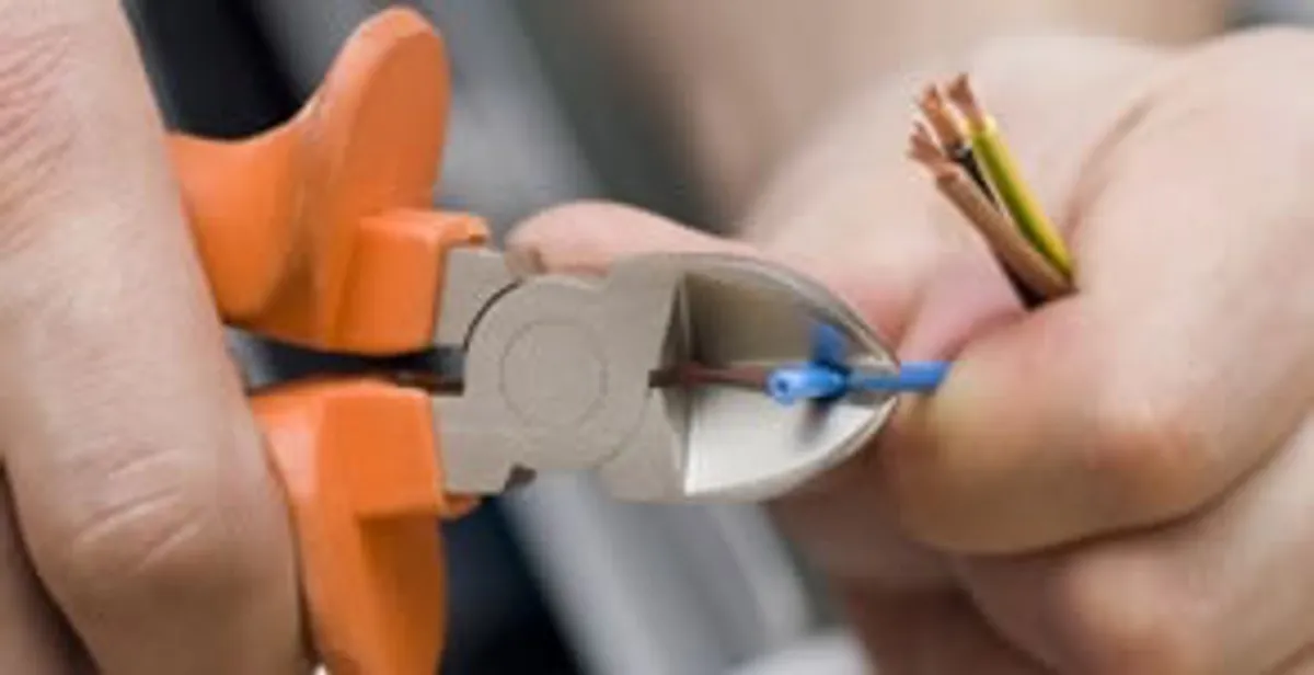 professional electrical services showing precise wire cutting by licensed electricians in Memphis, TN
